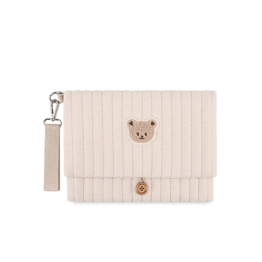 Pochette de voyage pliable pour parents nomades, super pratique pour un gain de place avec multiples compartiments de rangements de couleur beige ours
